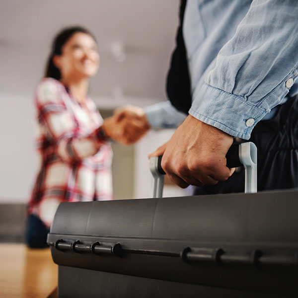 technician shaking hands with homeowner